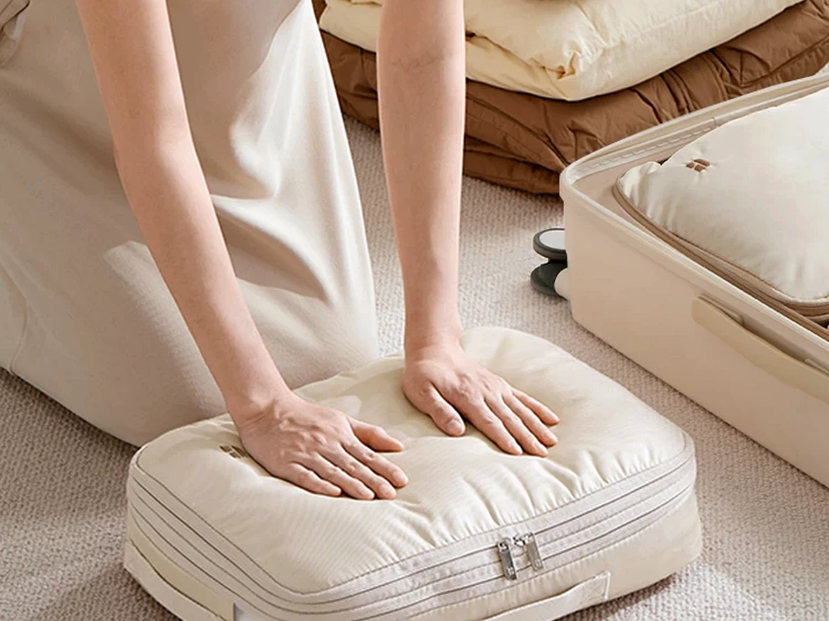 Travel compression organizer shown in a packing scene